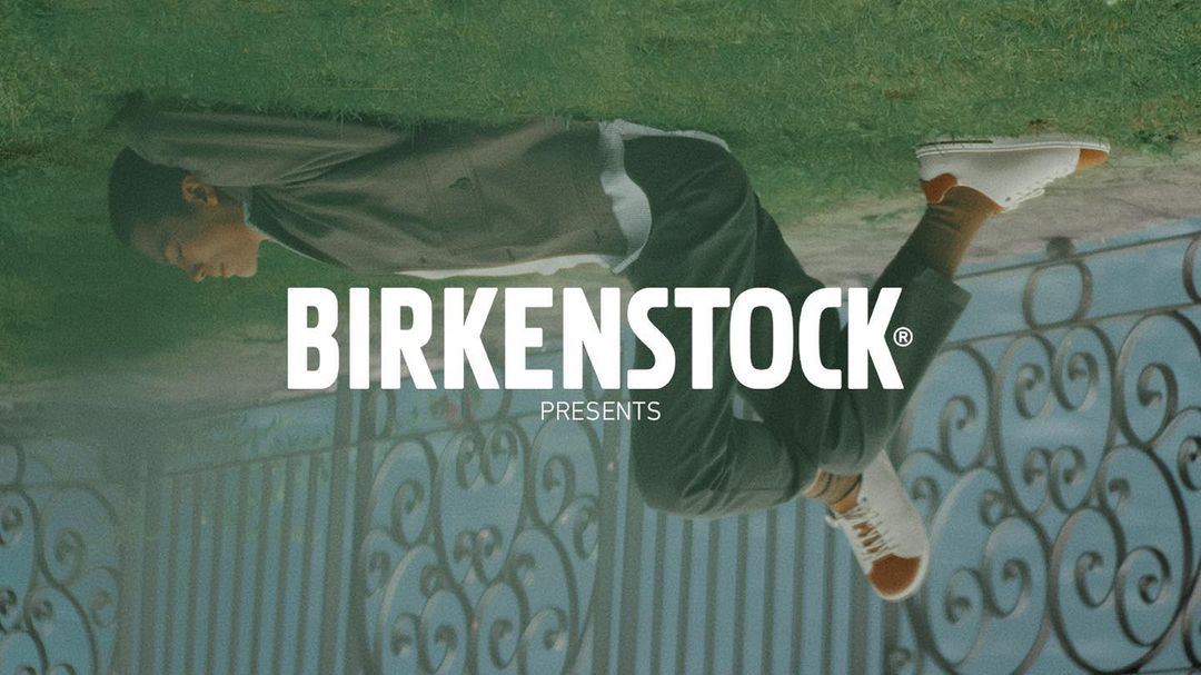An upside-down shot features a person in casual clothing, tan socks, and white Birkenstock sneakers, next to the Birkenstock logo.
