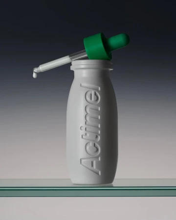 Studio shot of an Actimel bottle with a green dropper, featuring a minimalist composition against a gradient background.