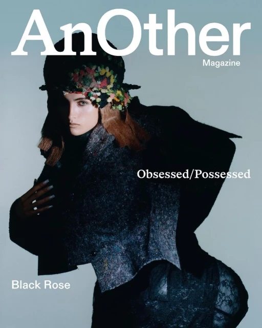 Magazine cover featuring a woman wearing an embellished hat and dark textured clothing, with 'AnOther Magazine' in white text.
