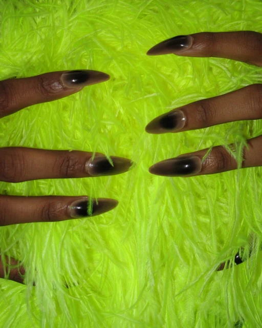 Close-up of six dark-skinned fingers with sharp almond-shaped nails, against a bright yellow-green feather-like textured background.