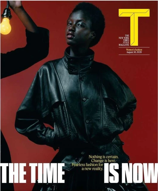 Magazine cover featuring a dark-skinned adult female model wearing a black leather jacket and an arm holding a lit lightbulb.