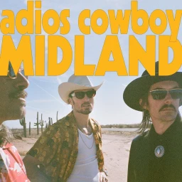 Three men in western shirts and sunglasses standing outdoors near cacti under a clear sky, photographed by Harper Smith.