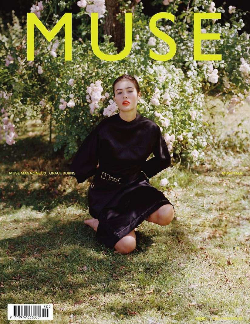 Magazine cover featuring a young adult woman kneeling on grass, surrounded by flowering bushes. Muse magazine is displayed at the top.