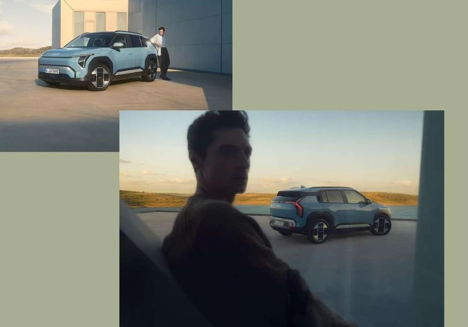Light blue SUV parked next to an adult male in a grey shirt; a modern automotive scene with neutral colours and a rural backdrop.