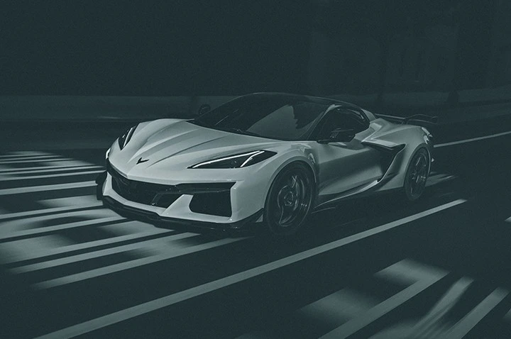 Sleek white sports car on a dimly lit road with prominent white stripes, showcasing a blend of modern design and high performance.