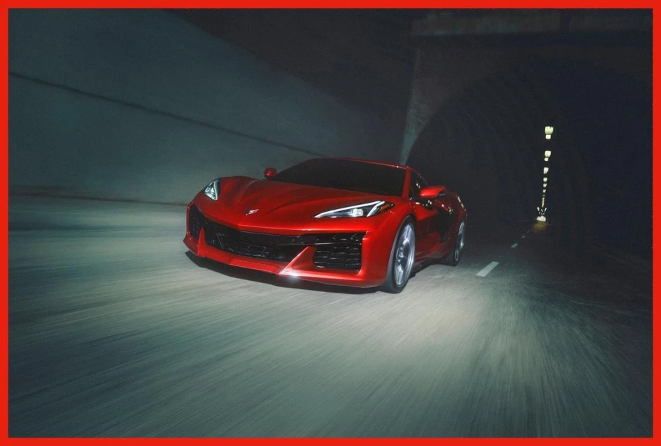 A vibrant red sports car speeds through a dark tunnel with motion blur, showcasing automotive performance and tunnel environment.