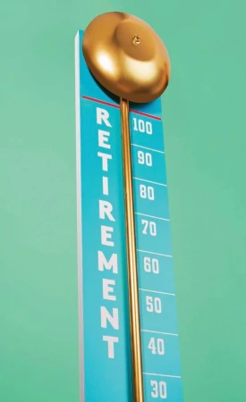 Retirement progress chart featuring a golden ball on a vertical scale with a mint-green background, indicating financial goal achievement.