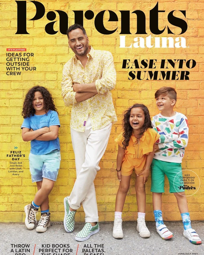 Man and four children smiling outdoors in front of a yellow brick wall with magazine typography overlay.