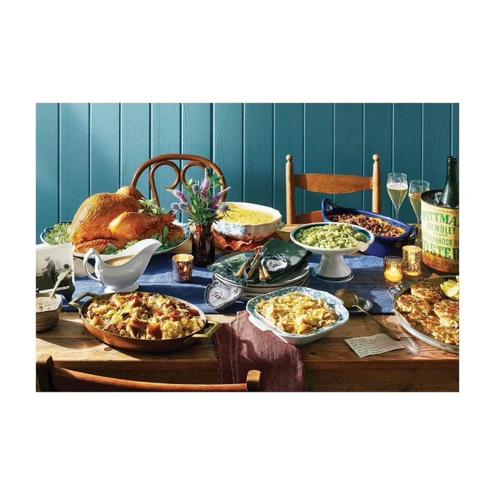 Feast spread with roast turkey, various side dishes, wine glasses, and a wine bucket on a wooden table in New York.