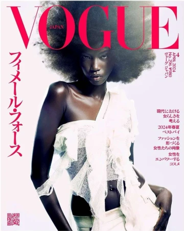 Vogue Japan cover featuring an African-American fashion model with an afro hairstyle in a white outfit against a light background.