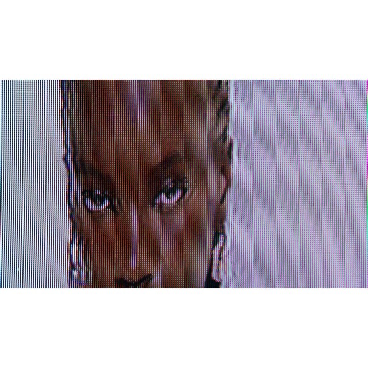 Close-up studio portrait of a Black woman with braided hair and neutral expression against a gradient backdrop, emphasizing skincare.