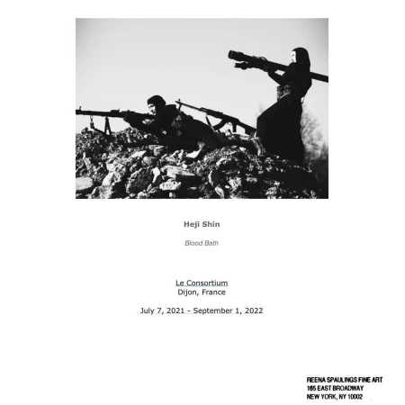 Black and white art photograph of two figures atop a stone structure holding weapons, against a clear sky.