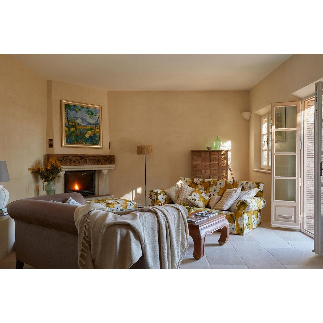 Warm and inviting living room featuring a fireplace, comfortable sofa, and stylish interior design elements creating a cozy atmosphere.