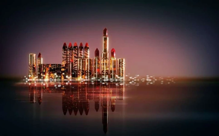 Stylized beauty product image: Red lipsticks arranged as city skyline on glossy surface with blurred lights against gradient background.