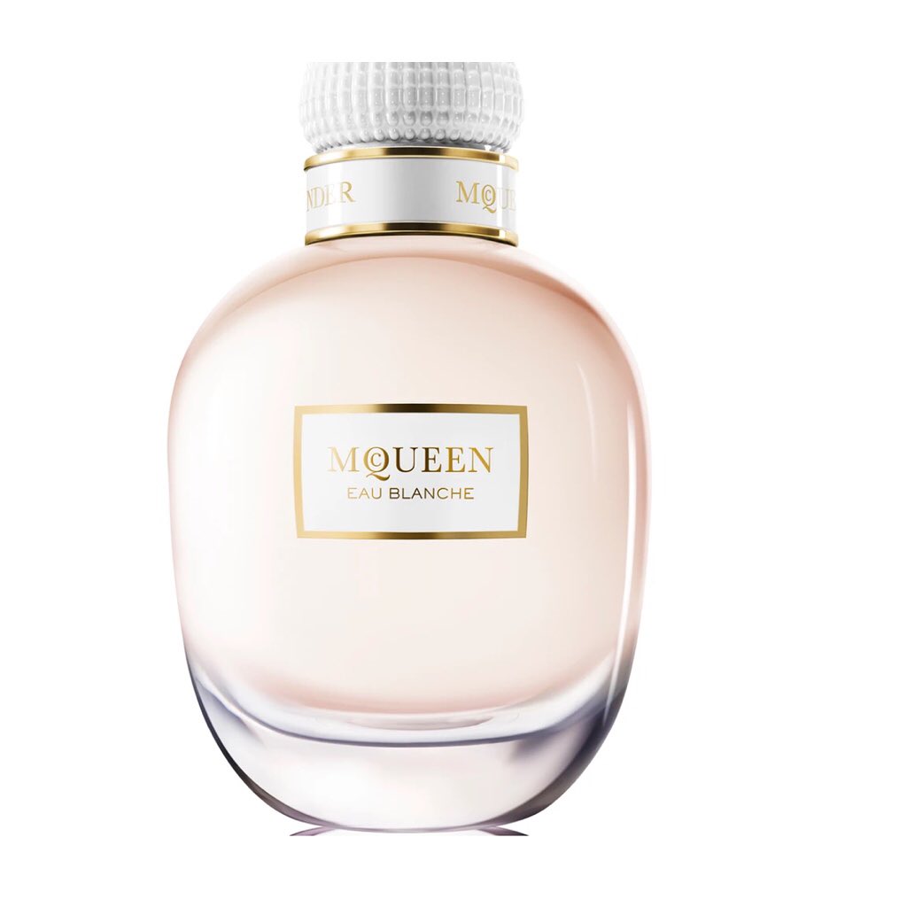 Elegant glass perfume bottle on a white background, featuring a white cap, a gold label, and smooth rounded design for beauty and fragrance.