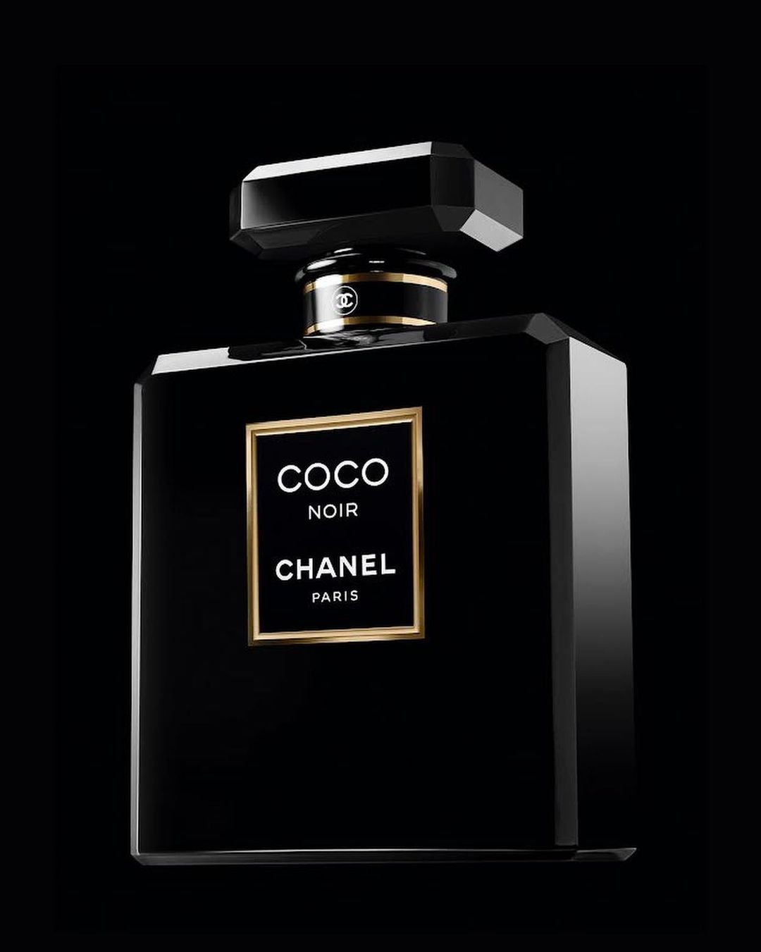 Chanel Coco Noir perfume bottle on a dark background with gold accents and elegant branding; product photography for beauty and fragrance.