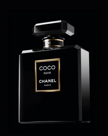 Chanel Coco Noir perfume bottle on a dark background with gold accents and elegant branding; product photography for beauty and fragrance.
