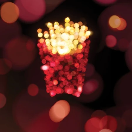 French fries are depicted with red and orange bokeh circles, creating a festive, abstract, and mouthwatering image against a dark backdrop.