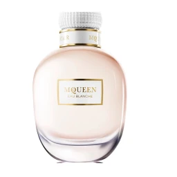 A perfume bottle named McQueen Eau Blanche with a pale pink liquid and a white cap against a white background.