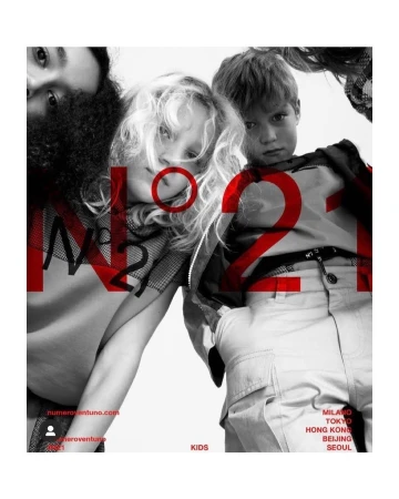 Fashion editorial shot from a low angle featuring two children and two adults in the background, with the brand name 'N21' overlaid in red.