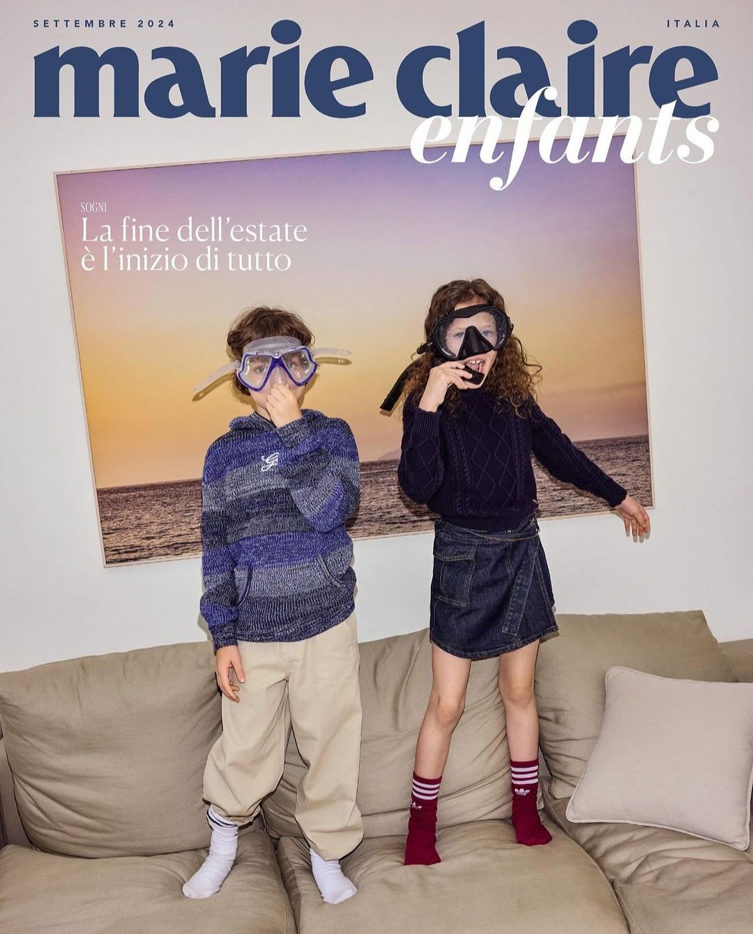 Marie Claire Enfants cover: two children wearing diving masks stand on a tan couch in front of a photograph of a beach at sunset.