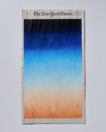 A digitally manipulated New York Times newspaper displays a blue, white, and orange gradient on a white background in a vertical shot.