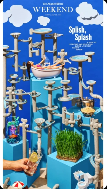 Conceptual art image of doll in a bathtub amid pipe structures, grass, pot of pasta, and a cocktail glass against a blue backdrop.