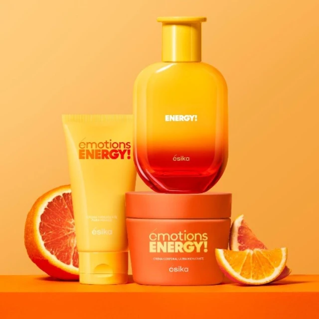 Cosmetic product display with a yellow-orange color scheme featuring a variety of skincare containers and sliced grapefruit.