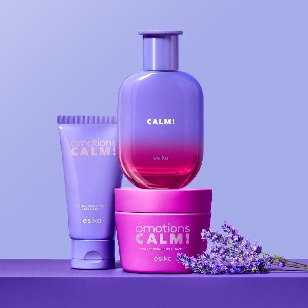 Esika Emotions Calm! product set featuring a cream tube, body cream, and perfume bottle, arranged on a purple surface against a lavender background.