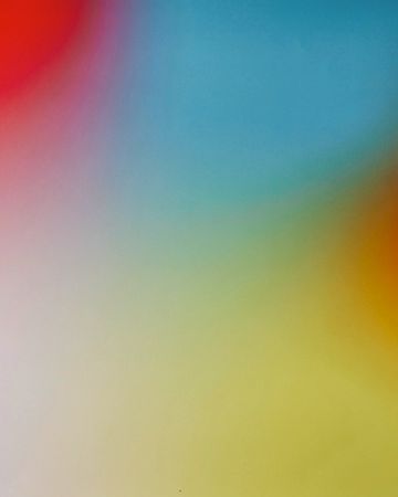 Abstract background with blurred gradient of red, orange, yellow, green, blue and white colors. Soft focus and smooth texture.