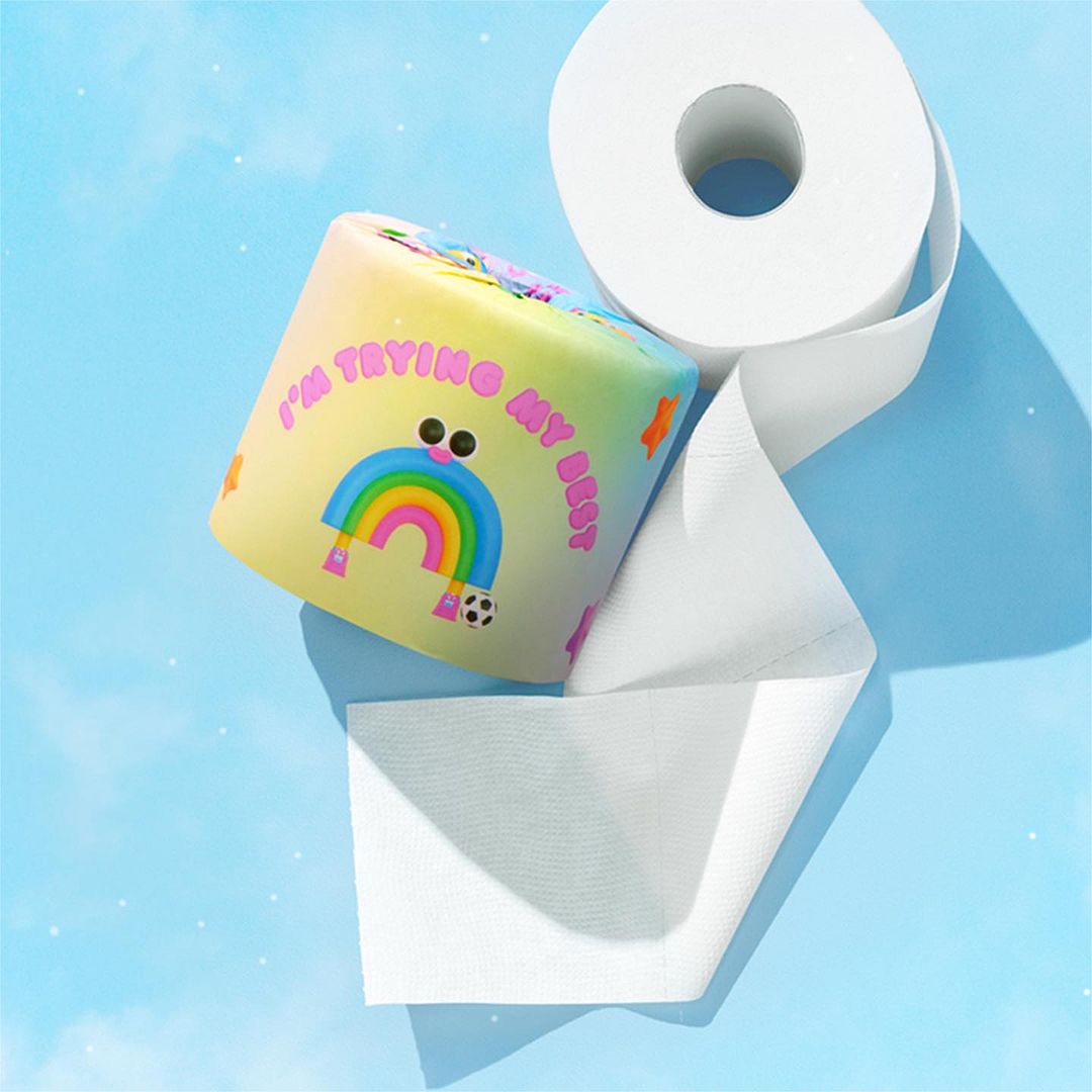 Cartoon-style toilet paper roll with rainbow and 'I'm trying my best' text on a blue cloud background, promoting mental wellness.