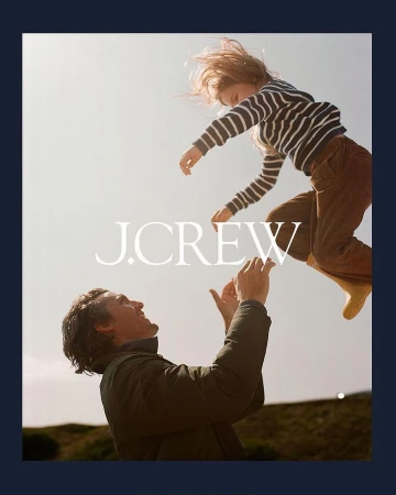 A joyful image captures a father looking up at his child mid-air, both smiling, under bright sunlight, with J.Crew logo overlay.