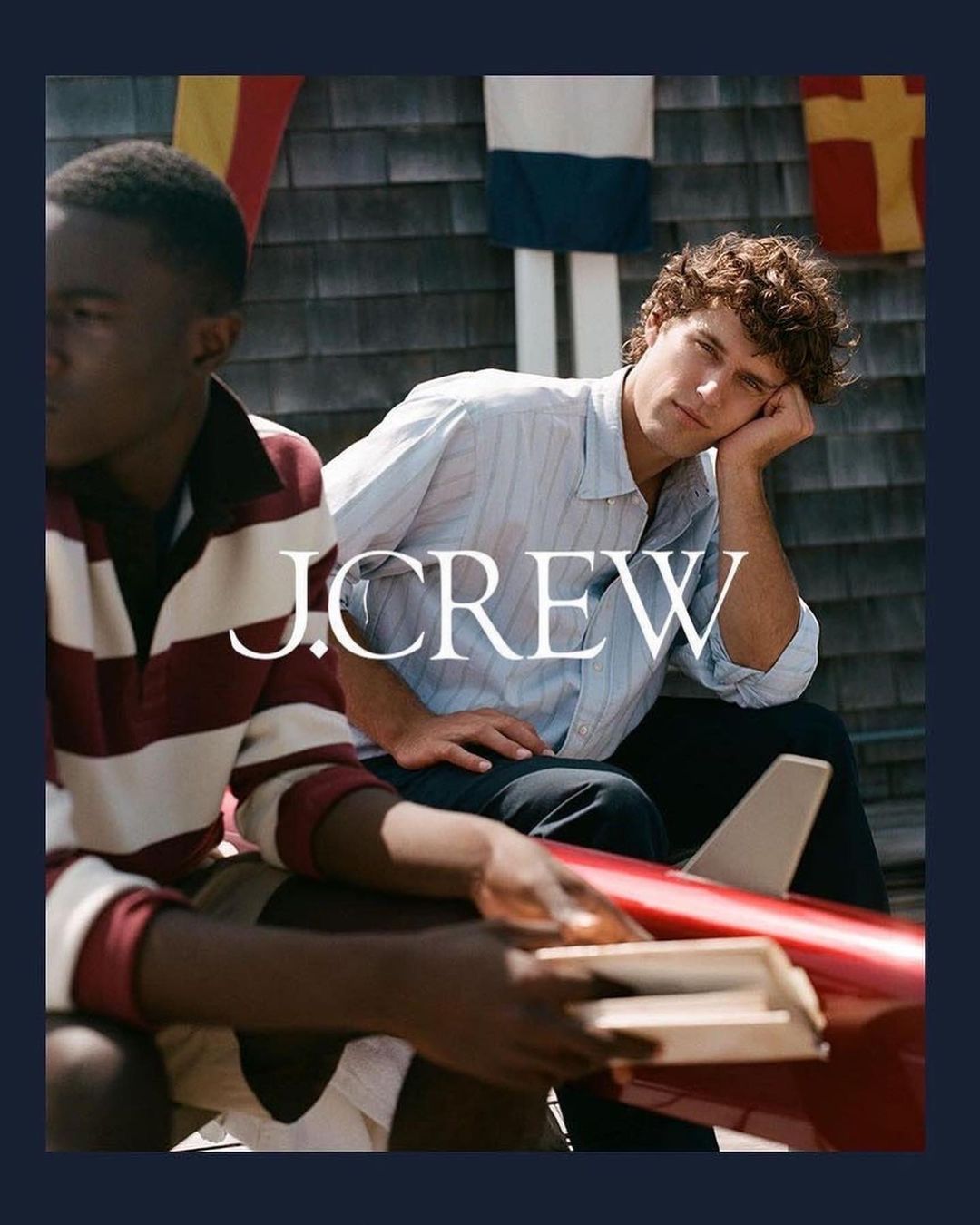 Two young adult men pose with a toy airplane outdoors on a sunny day in a fashion editorial, wearing J. Crew clothing and accessories.