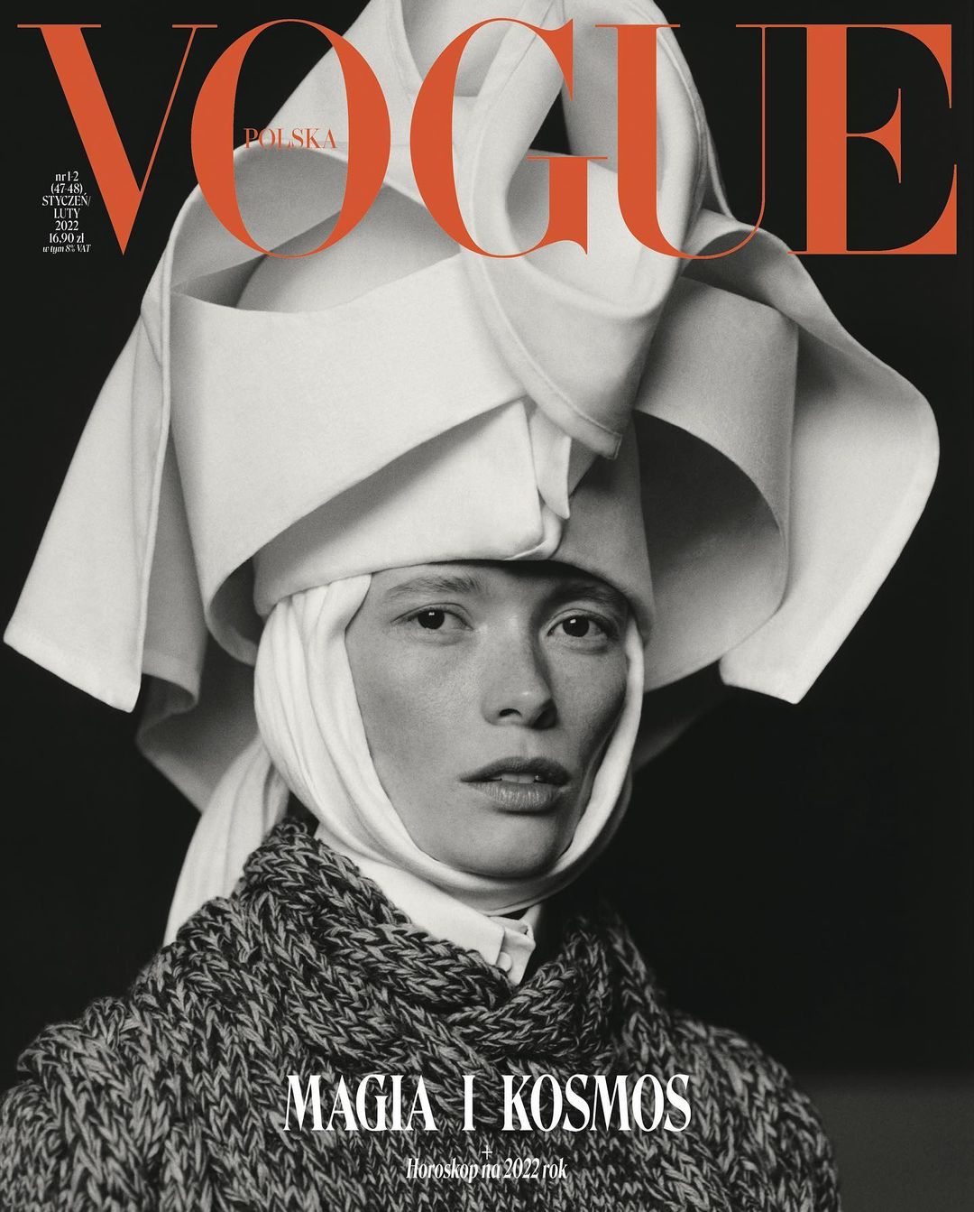 Vogue Polska magazine cover featuring a portrait of a woman with a serious facial expression wearing a white headdress and knit scarf.