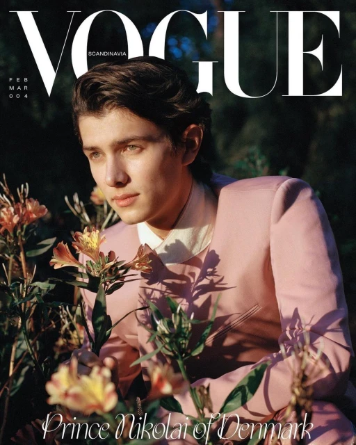 Vogue Scandinavia cover featuring Prince Nikolai of Denmark in a pink suit surrounded by flowers and greenery in an outdoor setting.