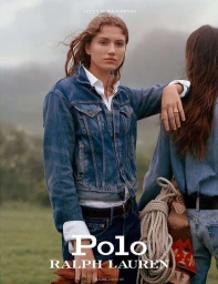 Two women in denim jackets and white shirts outdoors against an overcast background, photographed by Hill and Aubrey.