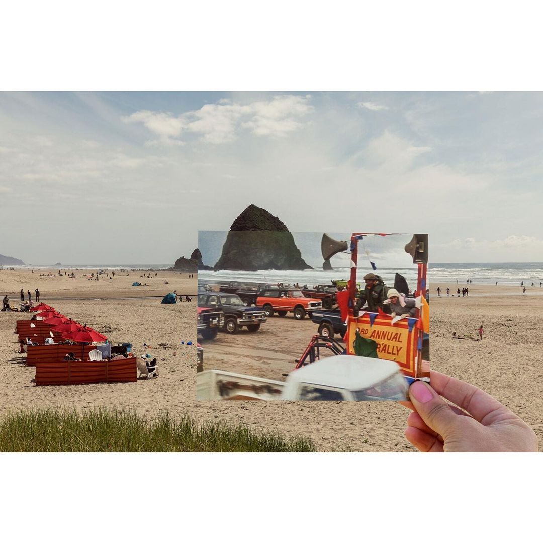 Seascape featuring people on a sandy beach with vintage cars in a photograph held up in front of Haystack Rock and the Pacific Ocean.