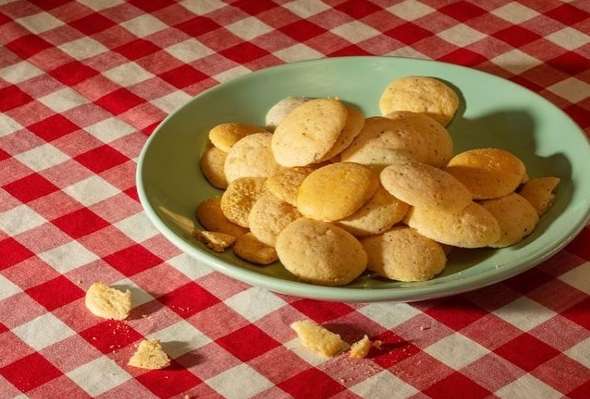 A plate of cookies on a red and white checkered tablecloth, food photography of a snack or dessert with a homemade vibe.