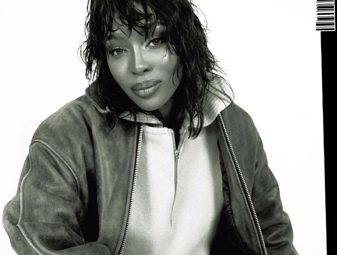 Headshot of an adult female with medium length dark hair, wearing a jacket and posing against a white background, with a partial barcode.