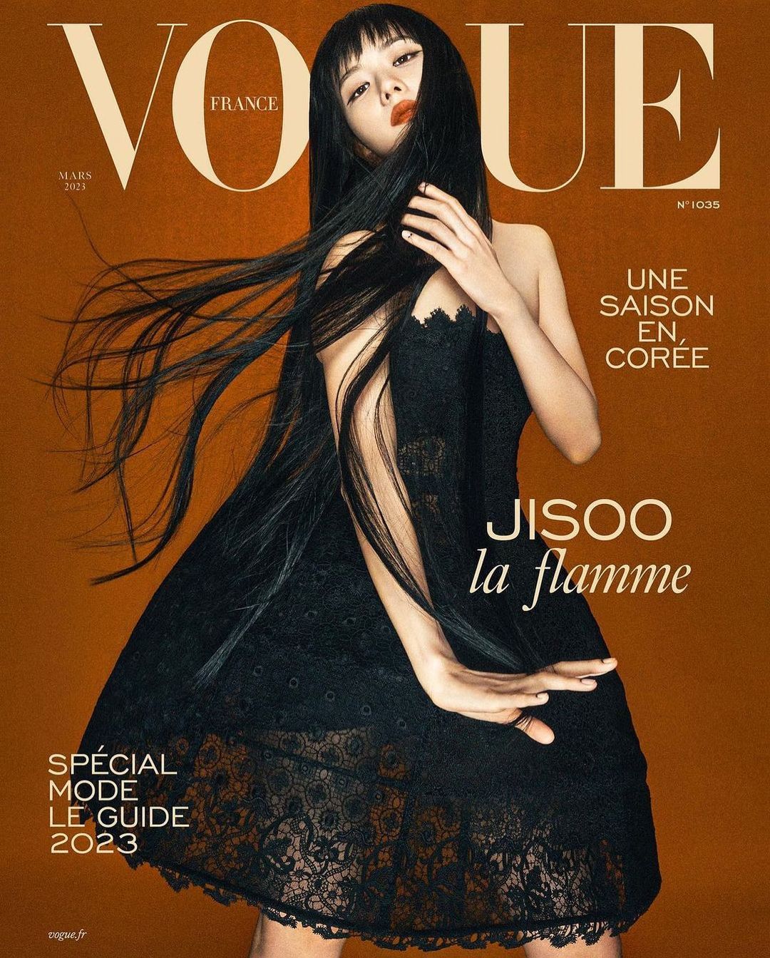 Vogue France cover featuring Jisoo in a black lace dress against a brown background with magazine text and the 'la flamme' subtitle.