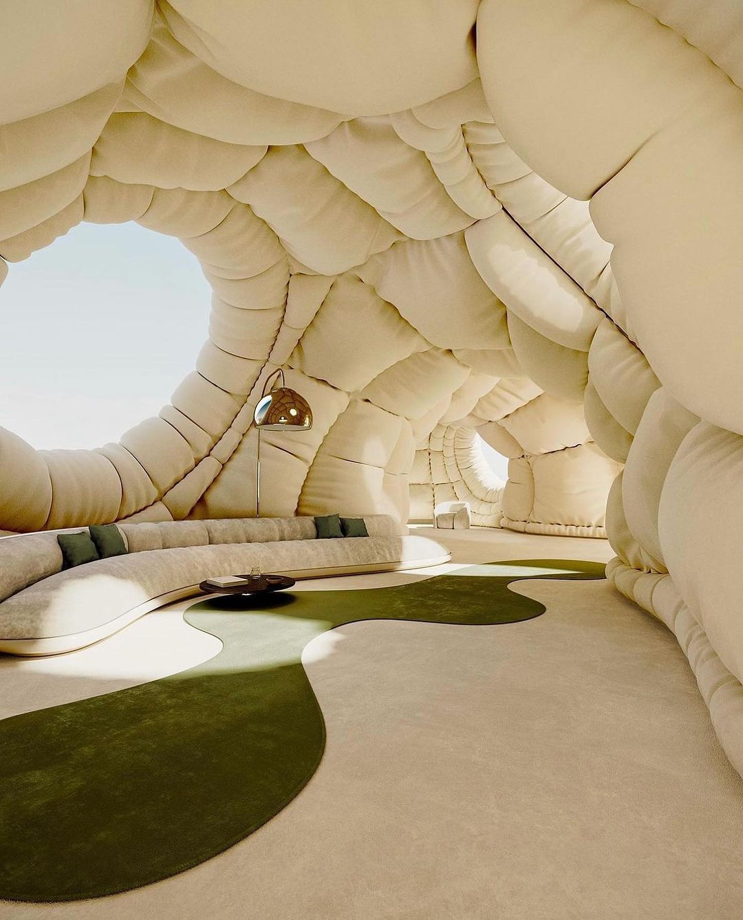 Unique interior featuring curved architecture, soft lighting, plush white seating, and a sculptural green rug creating a tranquil space.