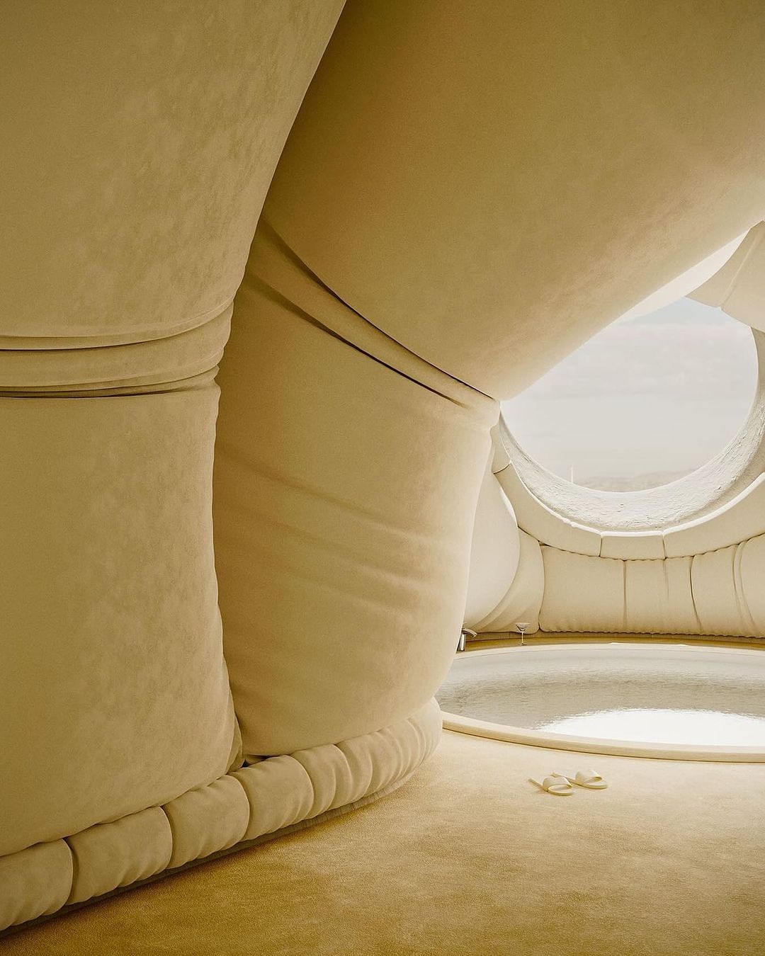 Padded, cave-like interior with round window and two off-white objects on the floor, illuminated by sunlight, creating soft shadows.
