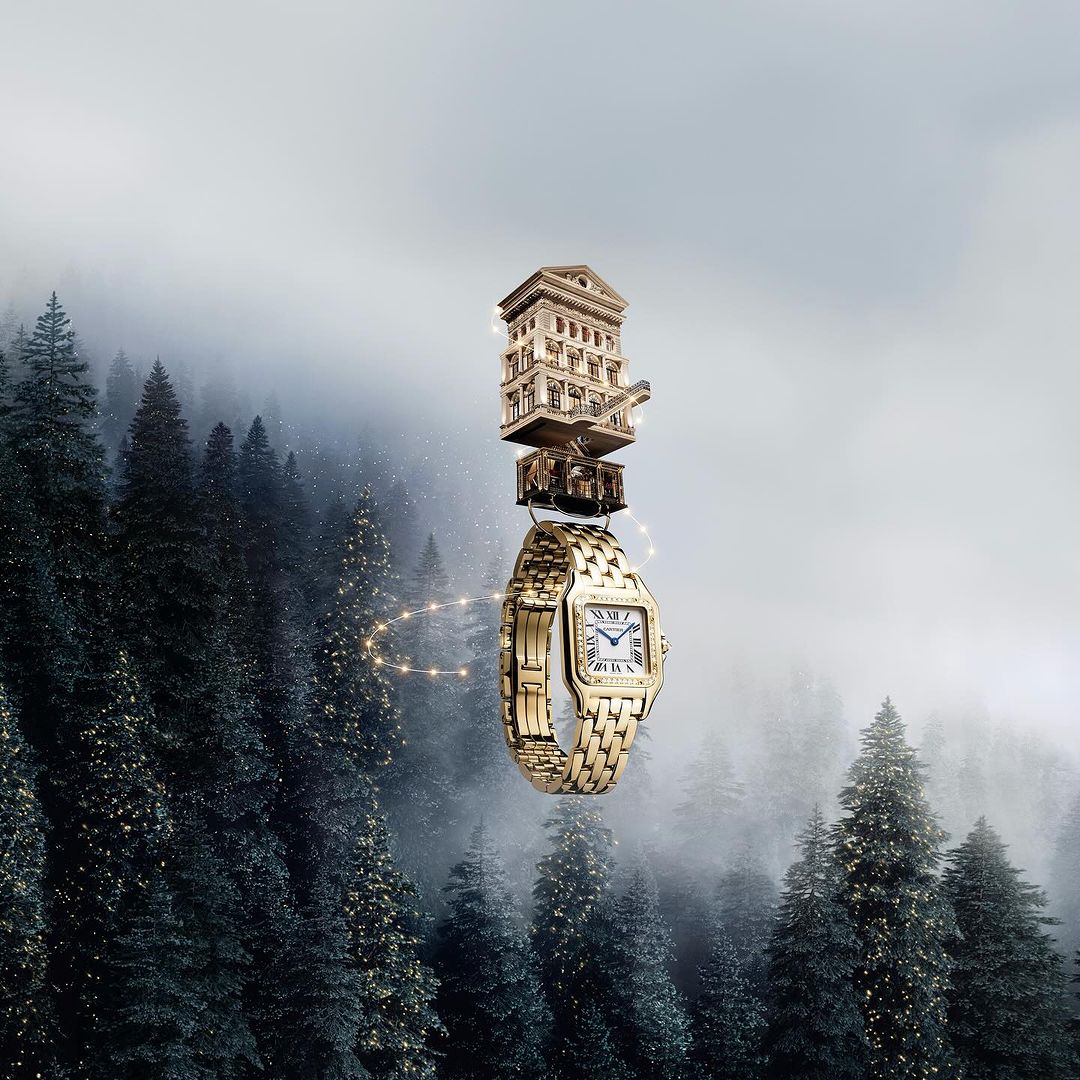 A surreal still life showcases a gold watch beneath a miniature architectural model, all set against a backdrop of misty forest trees.