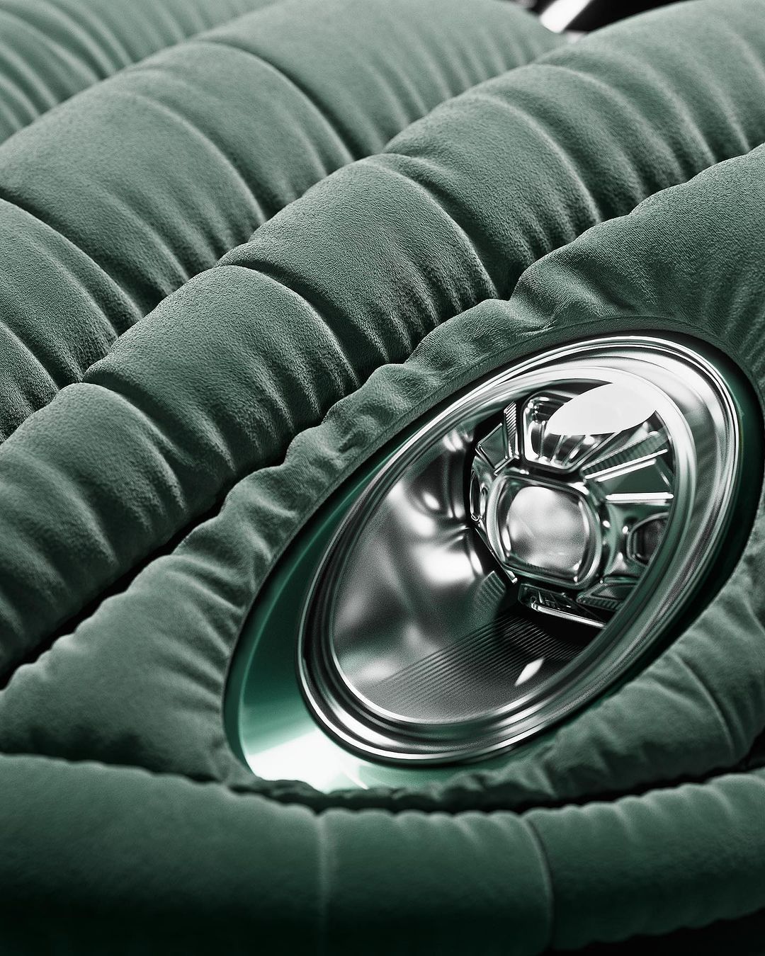 Close-up of a modern car headlight surrounded by quilted, sage-colored padding, highlighting automotive design and interior comfort.