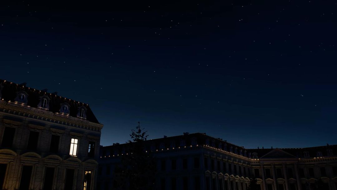 Night view of illuminated ornate buildings under a starry sky, creating a serene urban landscape.