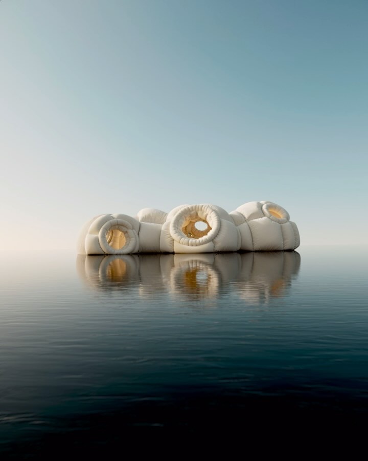 Abstract architecture on water: a white, modular building with circular openings is reflected in the dark water under a clear sky.