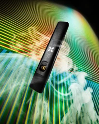 Black vape device angled against a vibrant striped rainbow background with curling white vapor wisps