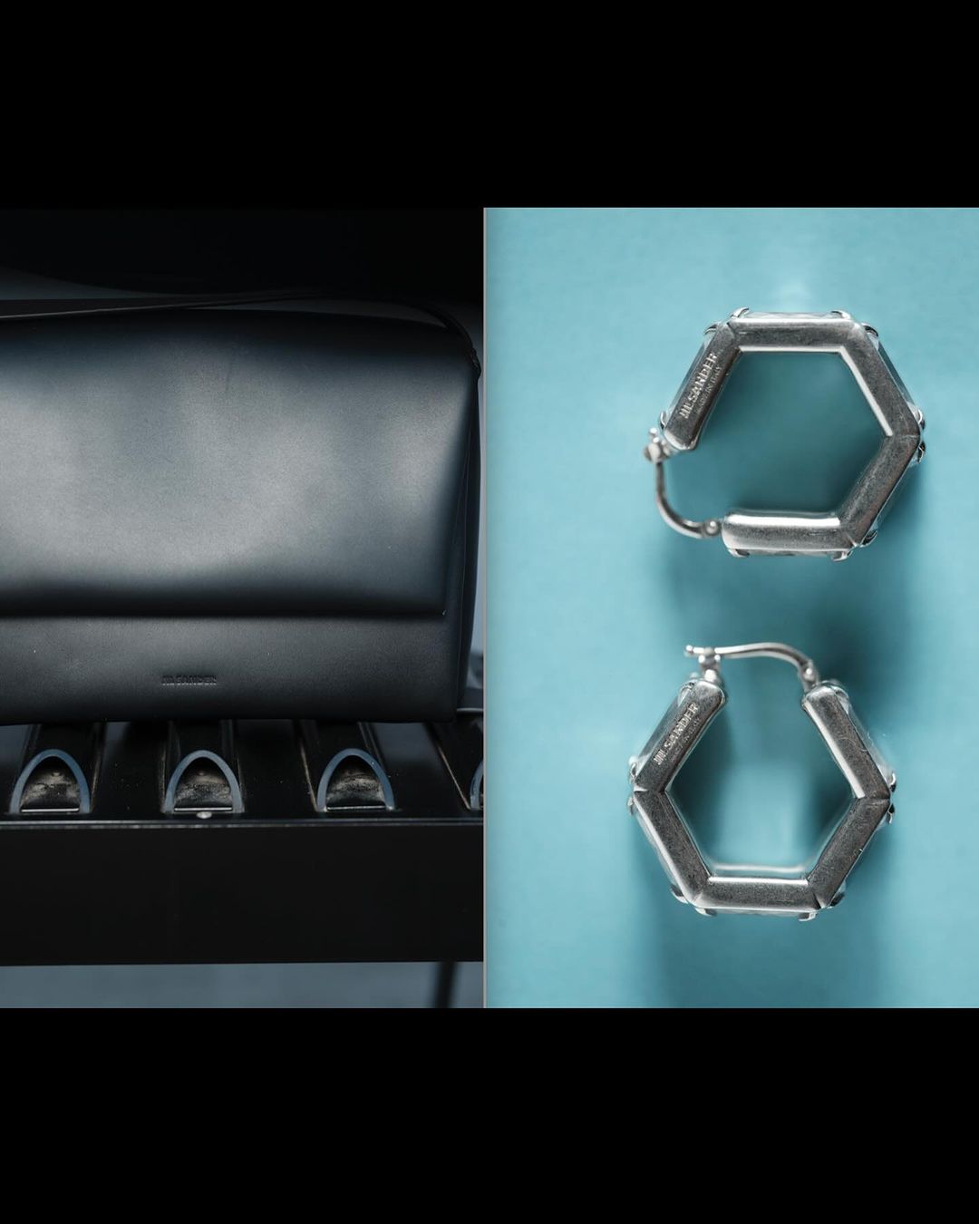 Studio product shot showcasing a structured black leather bag next to geometric silver hexagon-shaped hoop earrings on a bright surface.