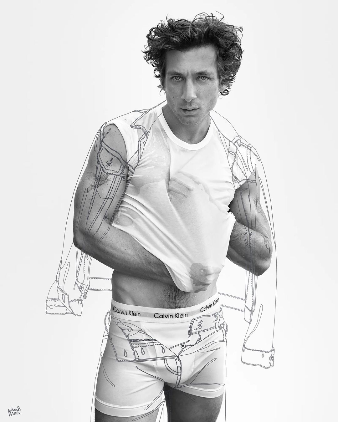 Black and white fashion shot of a curly-haired adult man partially removing his white tee shirt to reveal branded briefs, sketched denim details.