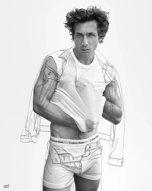 Black and white fashion shot of a curly-haired adult man partially removing his white tee shirt to reveal branded briefs, sketched denim details.